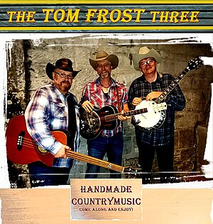 Das Bild zeigt drei Country-Musiker mit Banjo und Gitarren.
